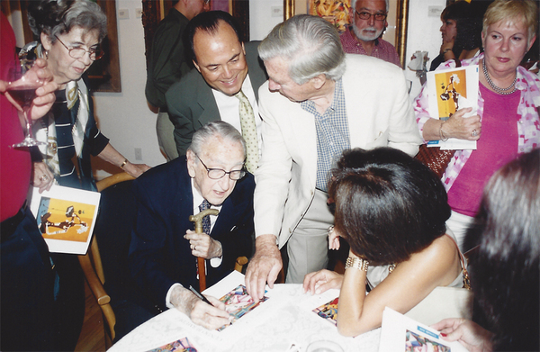Fans of the artist eagerly await Cundo's autograph. 