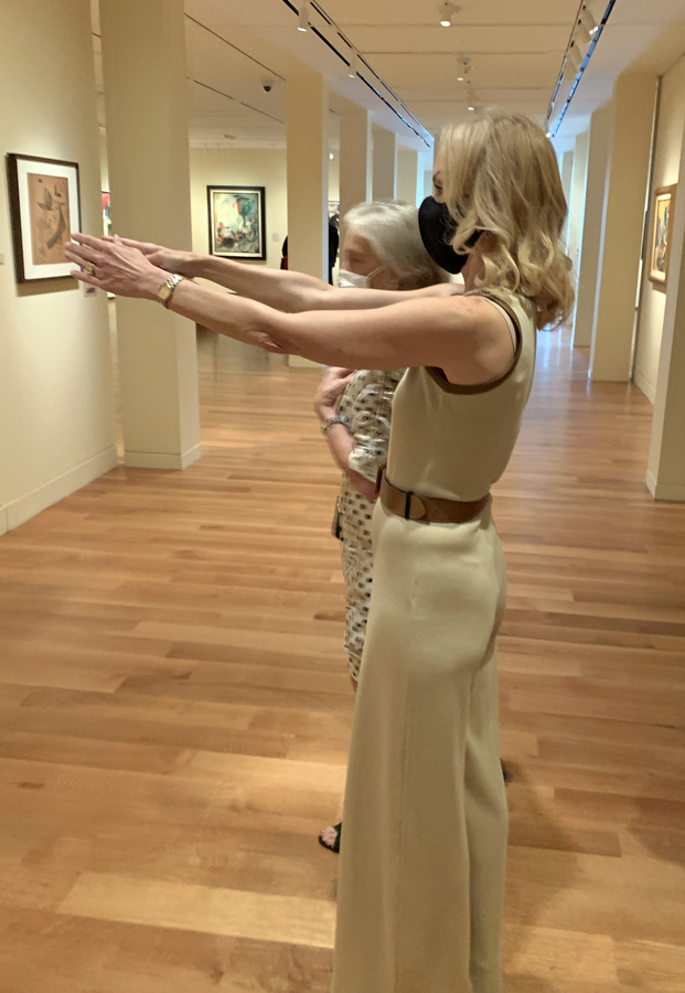 Exhibition curator Elizabeth Goizueta, <br>explaining a work to Marijean Miyar.<br><br><br>